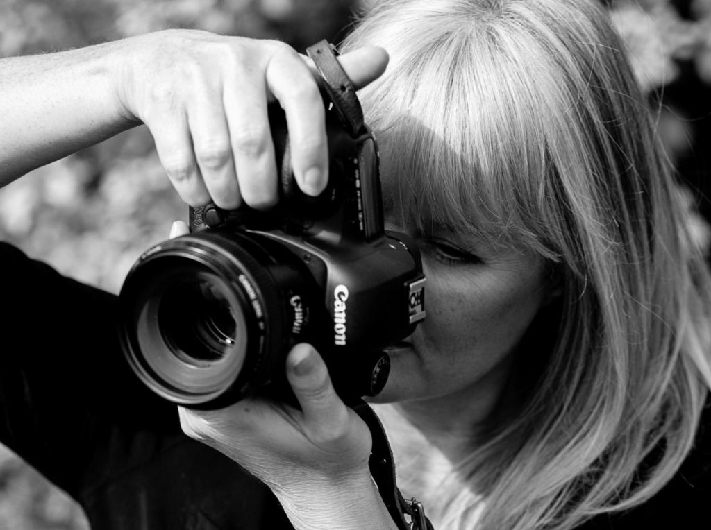 Lady taking a photograph with a large camera Burghley Horse Trials